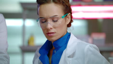Lab-researcher-in-laboratory.-Close-up-of-female-scientist-in-safety-glasses